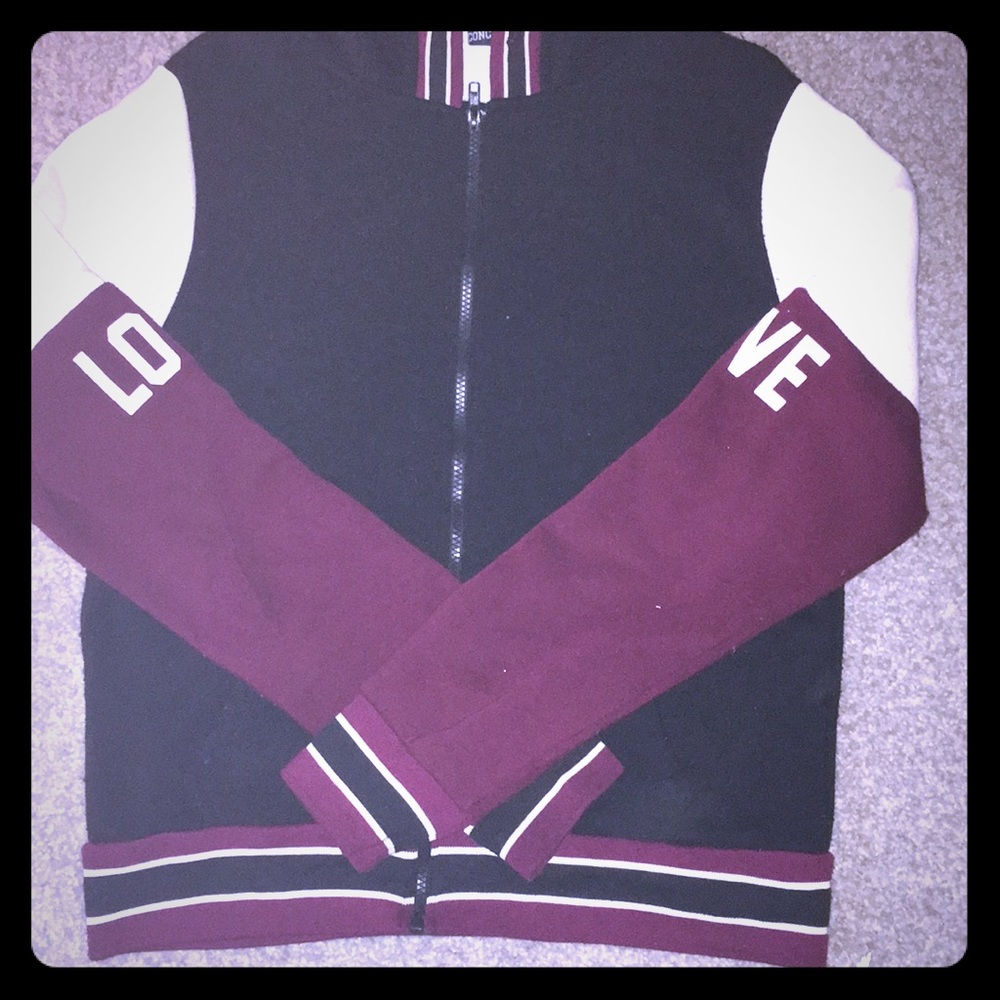 Burgundy, black and white jacket. It has been worn
